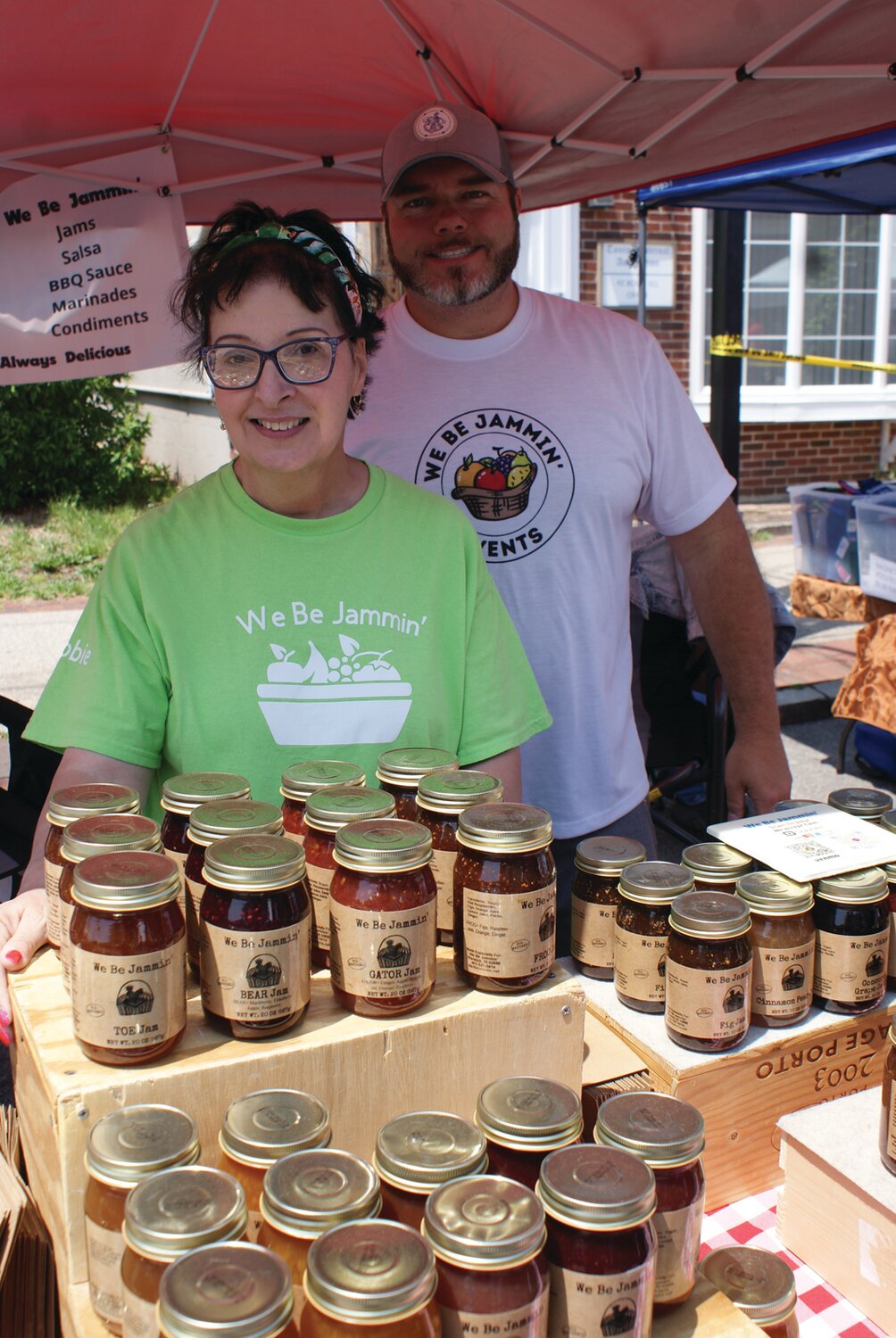 JOIN US THIS WEEKEND: Debbie Wood of We Be Jammin’ and Bryan LeBeau show off the jams and jellies available while taking in the amazing work Wood did in organizing the massive list of vendors at the 2023 Spring Festival earlier this year.